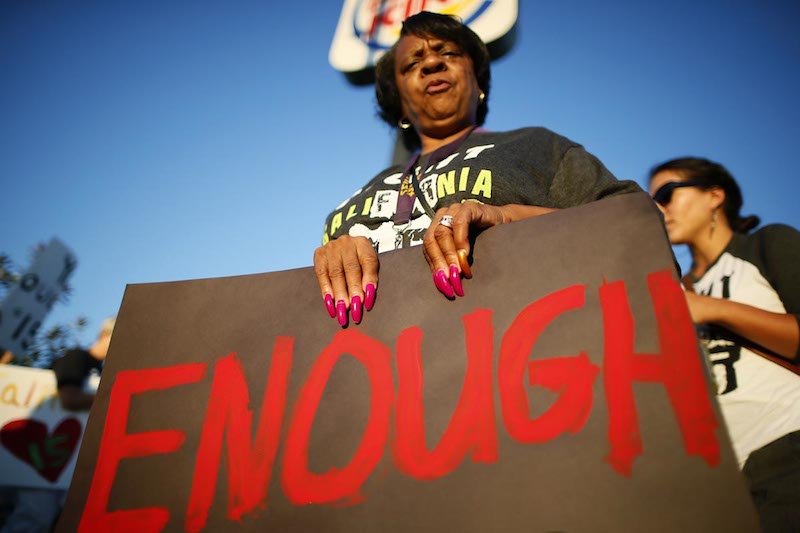 Workers and their supporters protest outside Burger King as part of a nationwide strike by fast-food workers to call for wages of $15 an hour, in Los Angeles, California